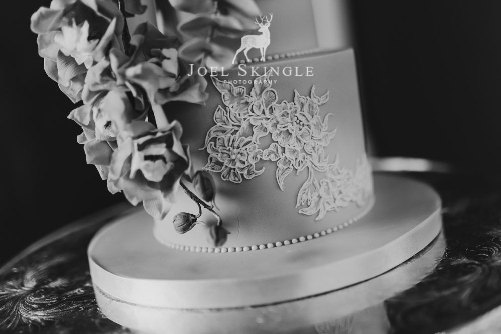 Close up hand piped lace wedding cake black and white image