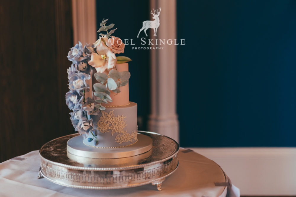 Blush pink and dusty blue floral cascade two tier wedding cake