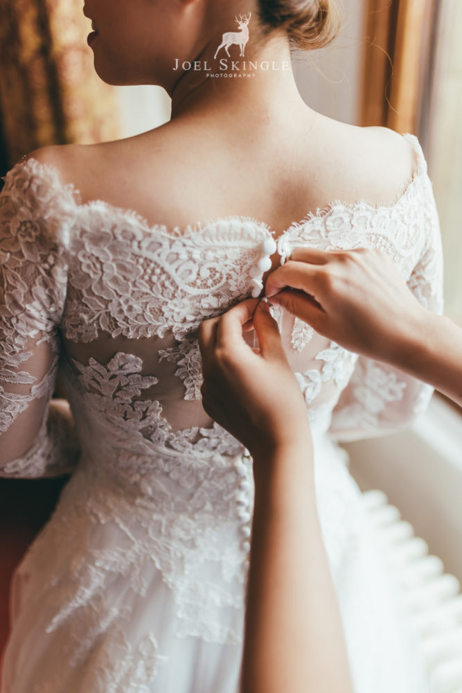 Buttoning wedding dress close up