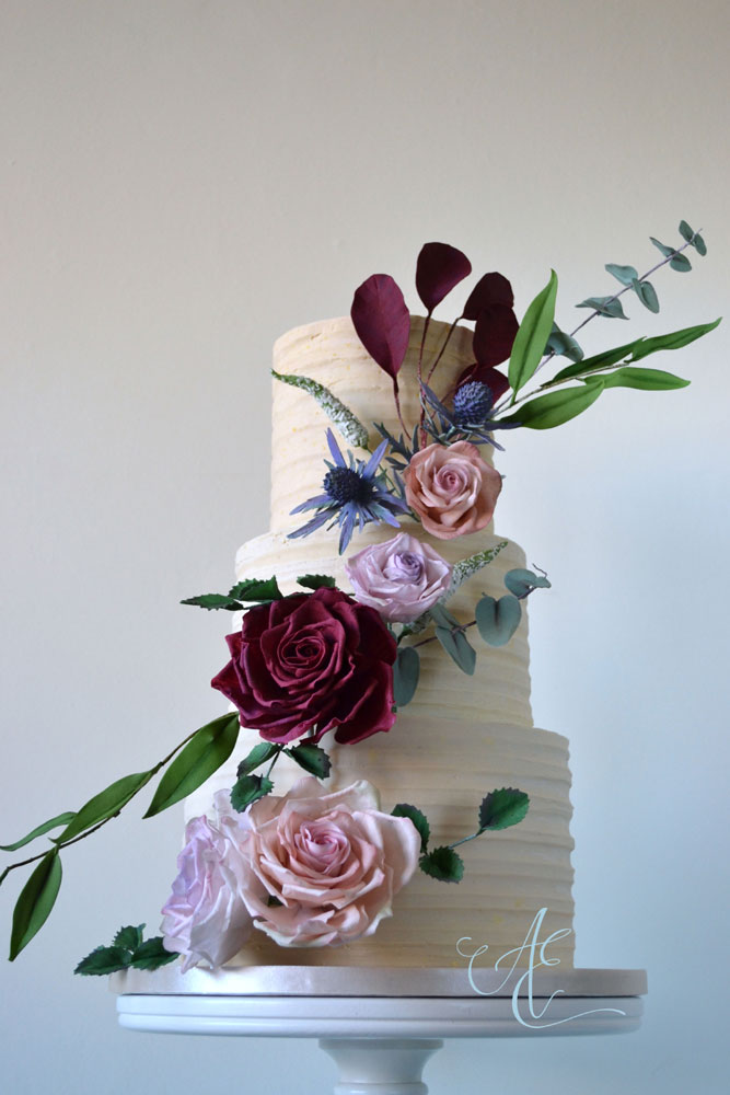 belgian chocolate ganache coated cake with autumnal flowers and foliage