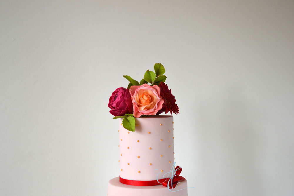 Gold polka dot top tier with sugar flowers