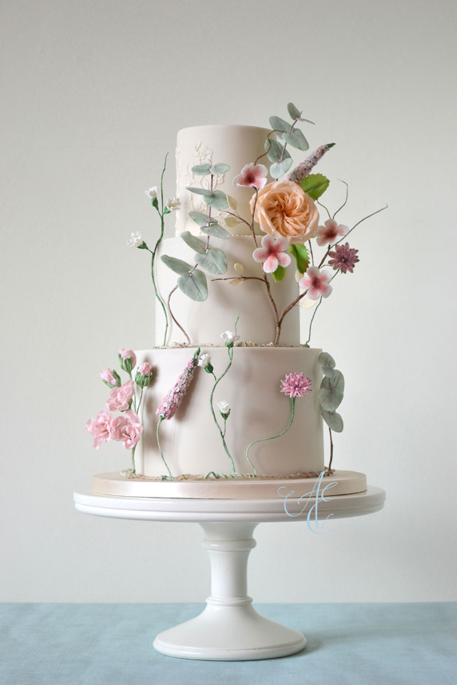vegan wedding cake with vegan sugar flowers and hand piping
