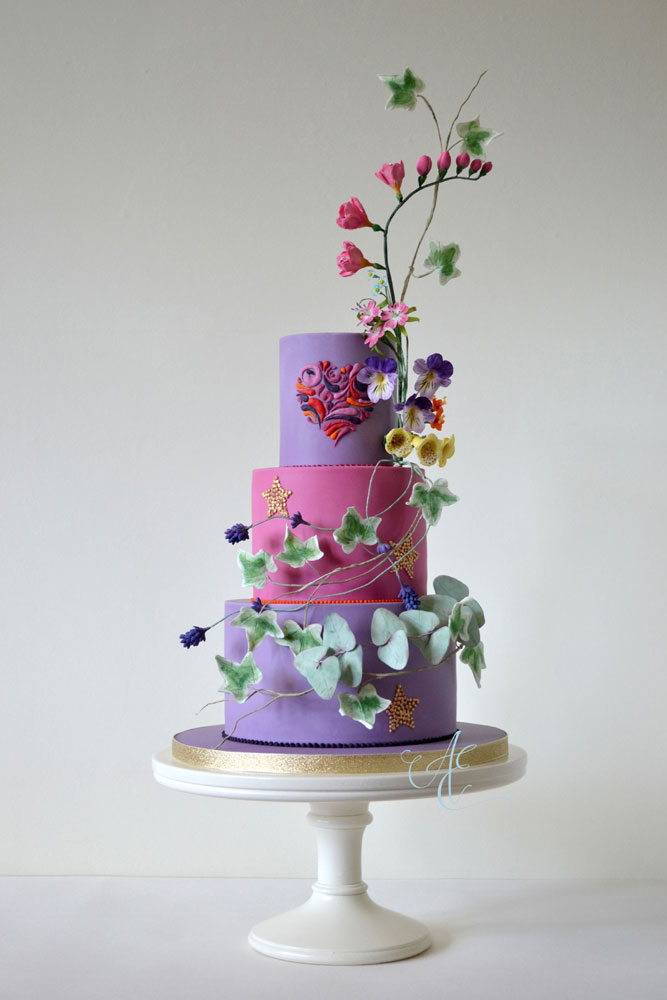 hot pink and pale purple vibrant vegan wedding cake with vibrant sugar woodland flowers