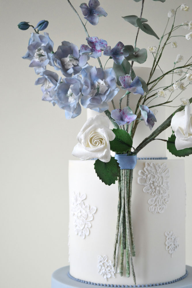blue white sugar floral wedding cake close up