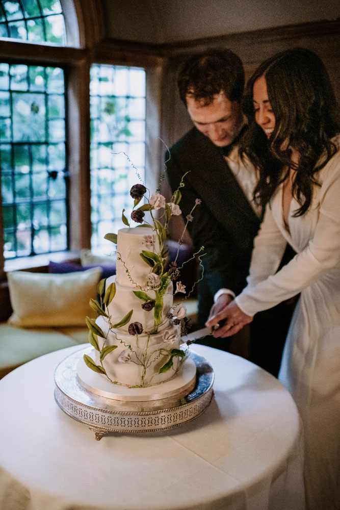 Newlyweds cutting their wedding cake