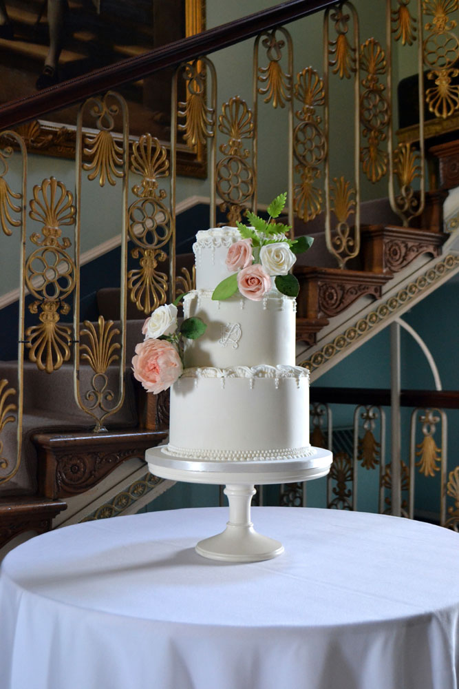 Ornate lambeth piped and roses wedding cake
