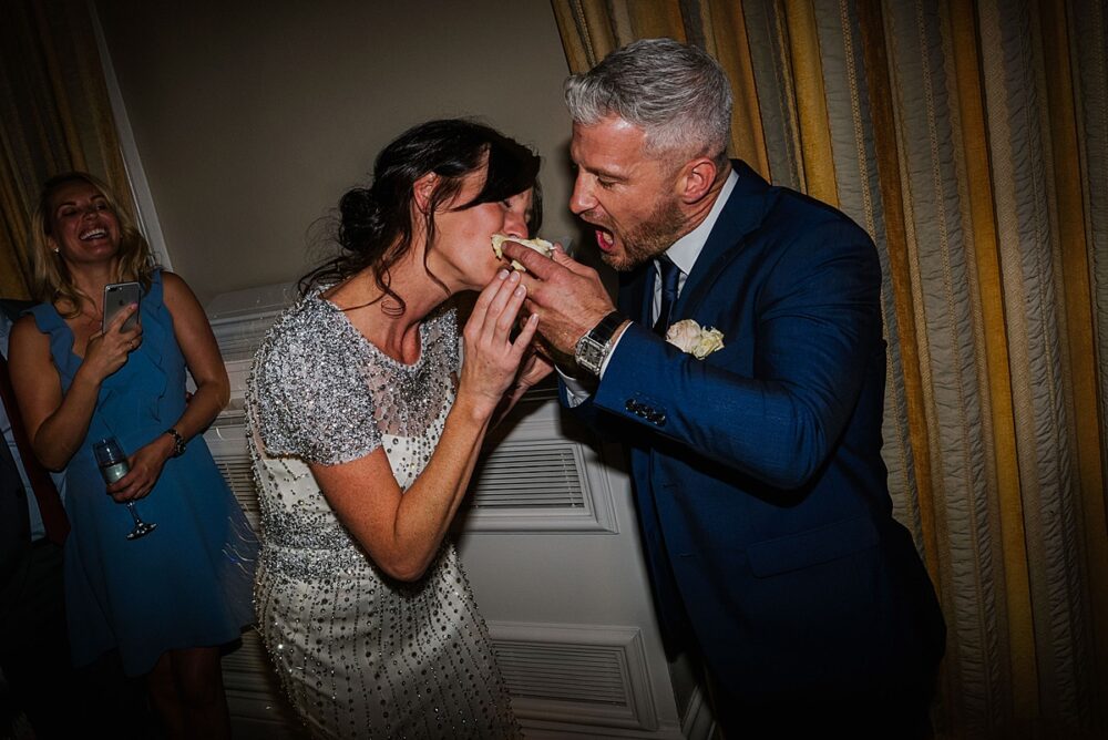 newlyweds eating wedding cake