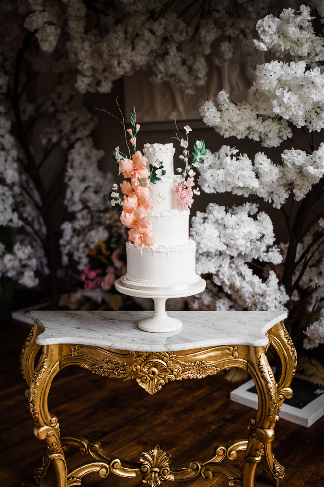 Lambeth and floral cake on marble and gilt table