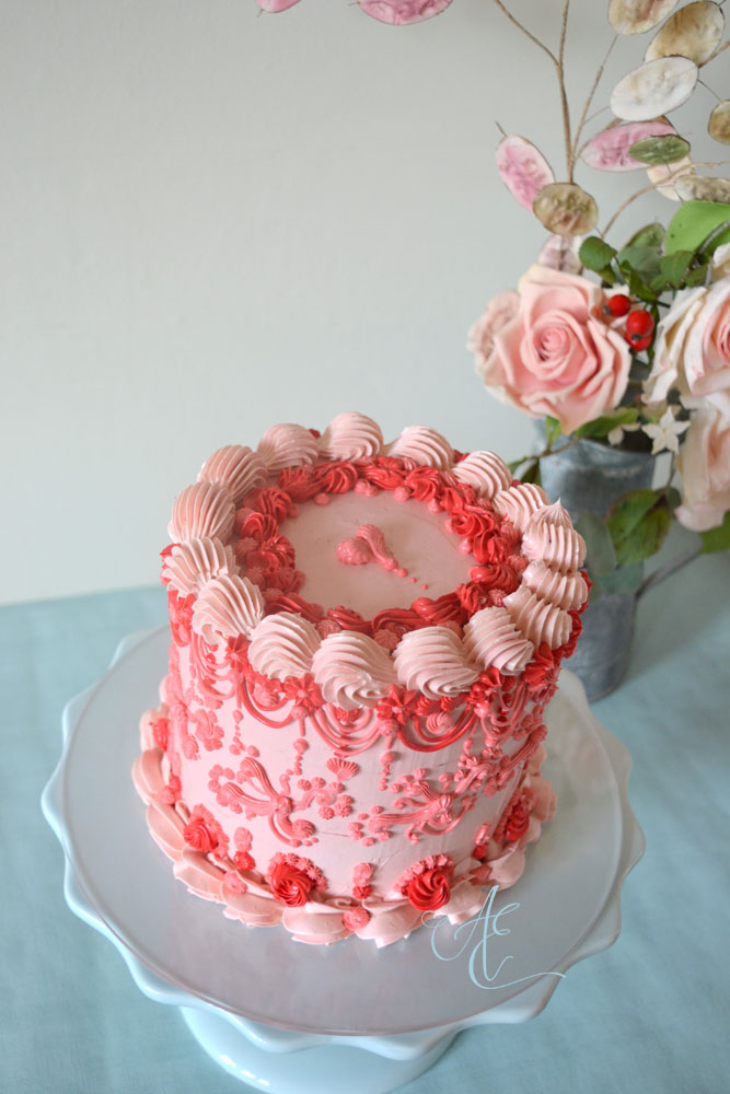 Ruby vintage style red and pink piped cake close up