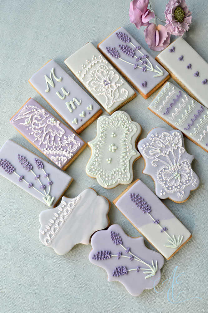 lavender sage green and dusky blue iced biscuits with hand piped lace and lavender flowers